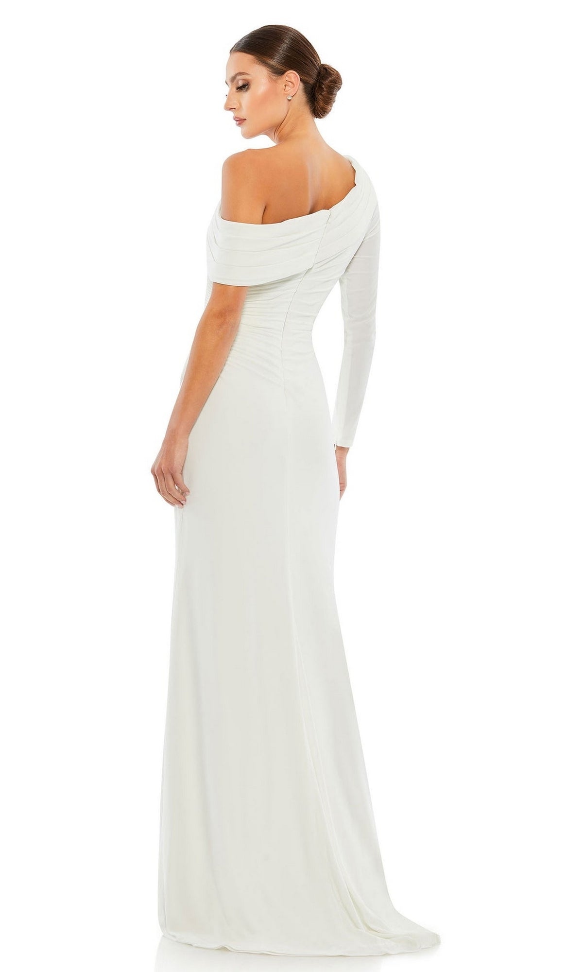 A woman stands with her back to the camera, wearing the Mac Duggal 26570 Drop-Shoulder Long Formal Dress with one sleeve and a fitted silhouette. Her hair is styled in a low bun, perfecting this elegant look.